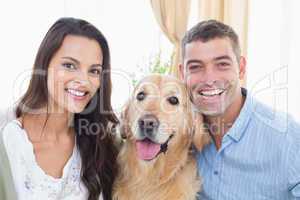 Happy couple with dog at home