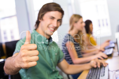 Student gesturing thumbs up in computer class