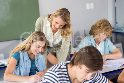 Teacher helping student in class