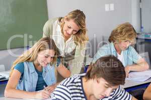 Teacher helping student in class