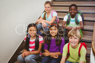 Children sitting on stairs in school