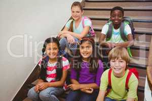 Children sitting on stairs in school