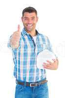 Confident manual worker gesturing thumbs up