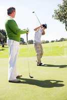 Golfing friends teeing off