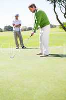 Golfing friends teeing off