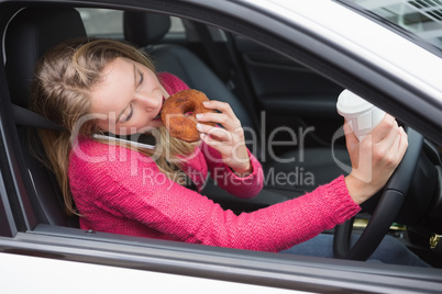 Young woman having coffee and doughnut