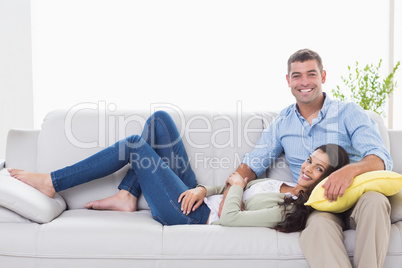 Happy couple on sofa at home