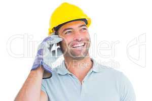 Smiling repairman talking on mobile phone