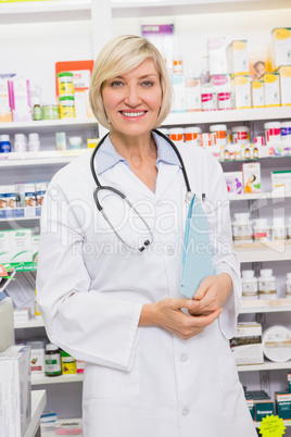 Smiling doctor with stethoscope holding files