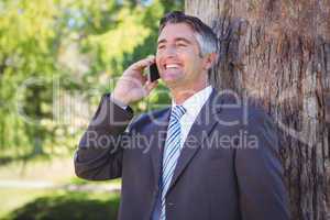 Businessman on the phone in park
