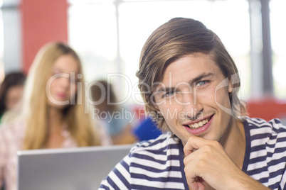 Smiling male student in classroom