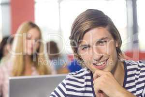 Smiling male student in classroom