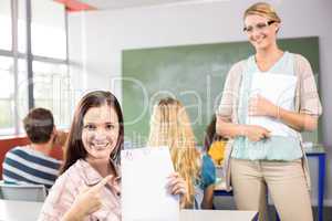 Beautiful female student pointing at paper