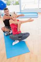 Happy fit couple working on exercise mat