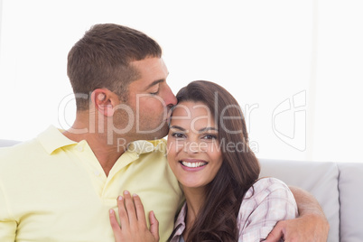 Happy woman being kissed by man