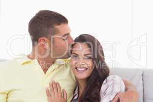 Happy woman being kissed by man