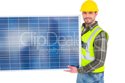 Handyman in protective clothing carrying solar panel