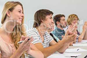 Students clapping hands in classroom