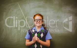 Llittle girl holding stick in front of blackboard