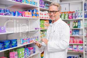 Senior pharmacist using tablet pc