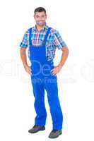 Handyman in coveralls standing hands on hip over white backgroun