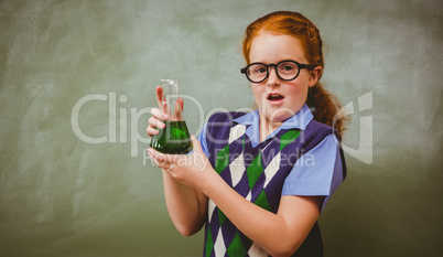 Girl holding conical flask in classroom