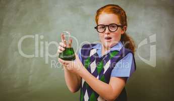 Girl holding conical flask in classroom