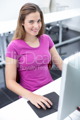 Student smiling at camera in computer class
