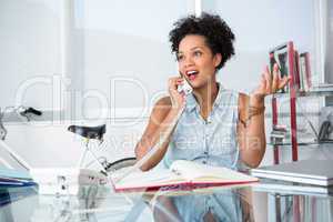 Casual young woman using telephone