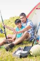 Father and son beside tent