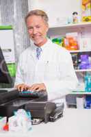 Senior pharmacist using the computer