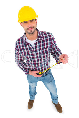 Smiling handyman holding tape measure