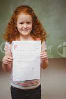 Portrait of cute little girl holding paper