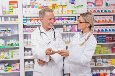 Pharmacist speaking with his trainee about medicine