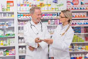 Pharmacist speaking with his trainee about medicine