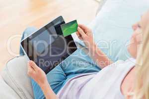 Woman doing online shopping on digital tablet at home