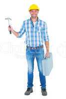 Full length portrait of repairman with hammer and toolbox