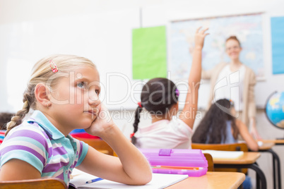 Thoughtful pupil sitting at her desk