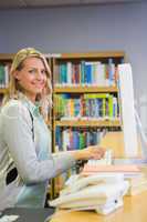 Pretty librarian working in the library