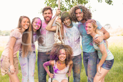 Happy friends covered in powder paint