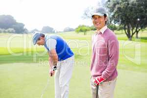 Golfing friends on the putting green