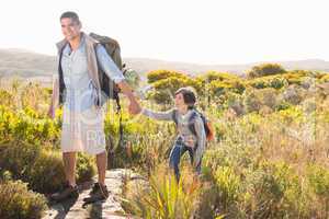 Father and son hiking through mountains