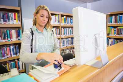 Pretty librarian working in the library