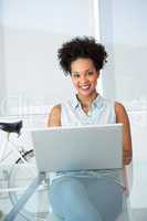 Beautiful young casual woman using laptop