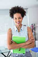 Portrait of smiling young woman with file