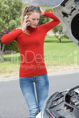 Stressed woman looking at engine