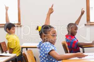 Pupils raising hand in classroom