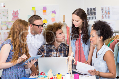 Designers using laptop and digital tablet