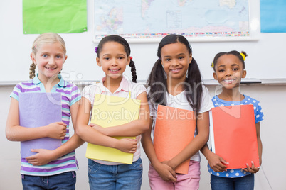 Cute pupils smiling at camera during class presentation