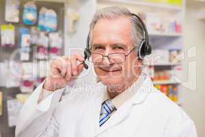 Smiling senior pharmacist with headphone